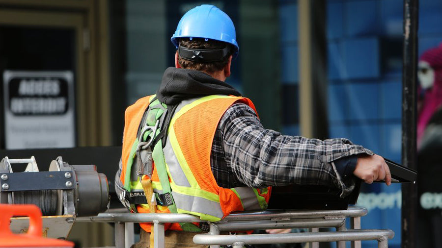 Man wearing an ANSI 107 Safety Vest Working