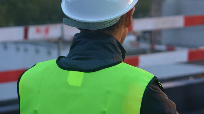 Man wearing a safety vest and hard hat