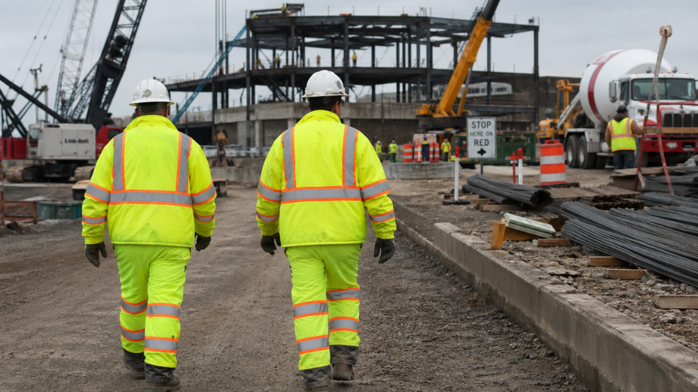 workers wearing green class 3 high visibility gear